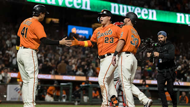 SF Giants outfielder Joc Pederson, infielder Wilmer Flores, and catcher Andrew Knapp celebrate after Pederson's three-run homer.
